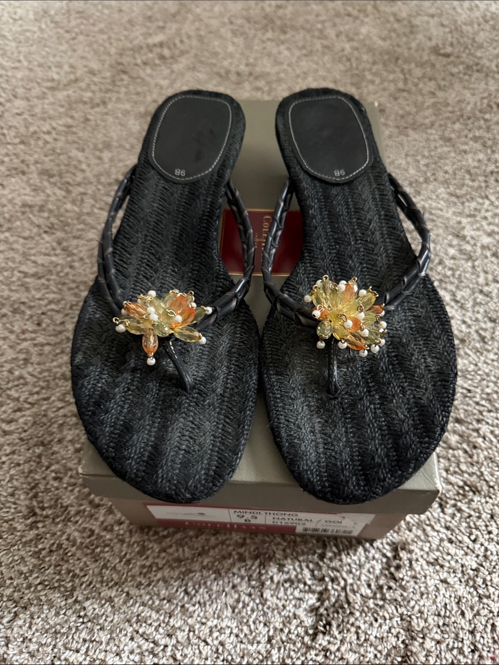 Cole Haan Black Woven Sandal with decorative flower.